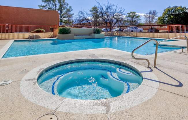 a hot tub next to a swimming pool