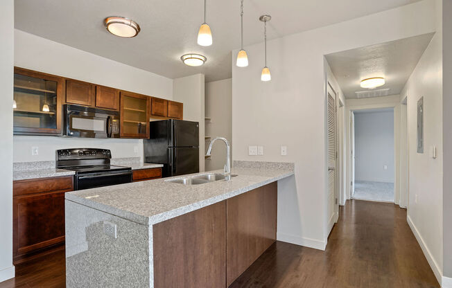 a kitchen with an island with a sink and a stove