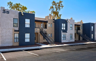 A row of modern townhouses with a clear blue sky above.