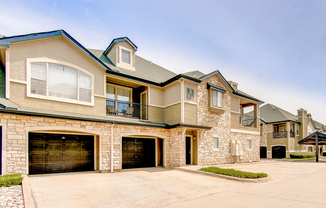 View of Building Exterior, Showing Balconies and Attached Garages at Stonebriar of Frisco Apartments