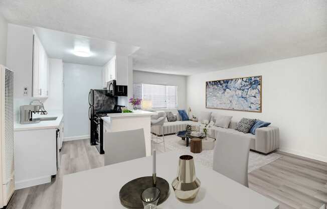 an open living room and kitchen with a white table