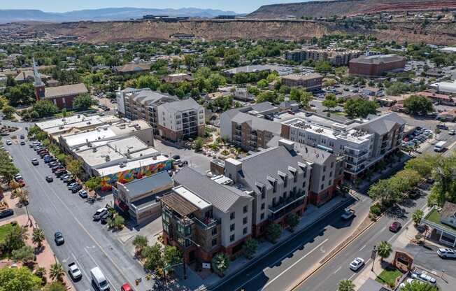 an aerial view of a city with buildings and cars on the street