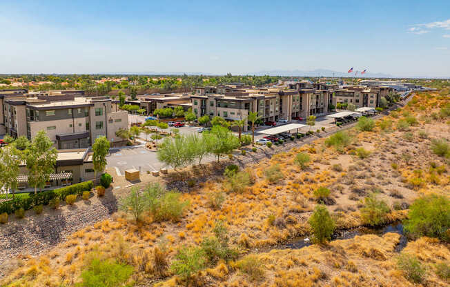 A large building complex sits in a dry, arid landscape.