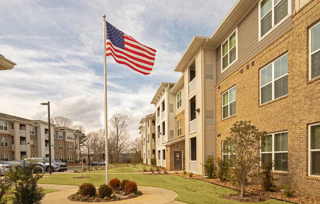 A building with an American flag on a pole in front of it.