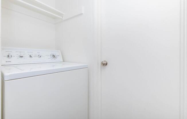 a cat sitting on top of a refrigerator