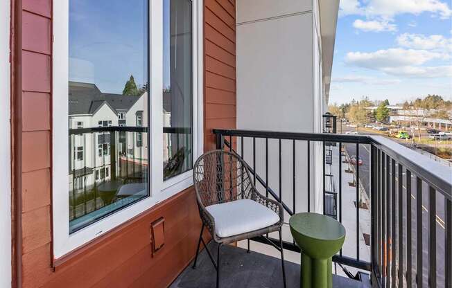 A balcony with a chair and a table.