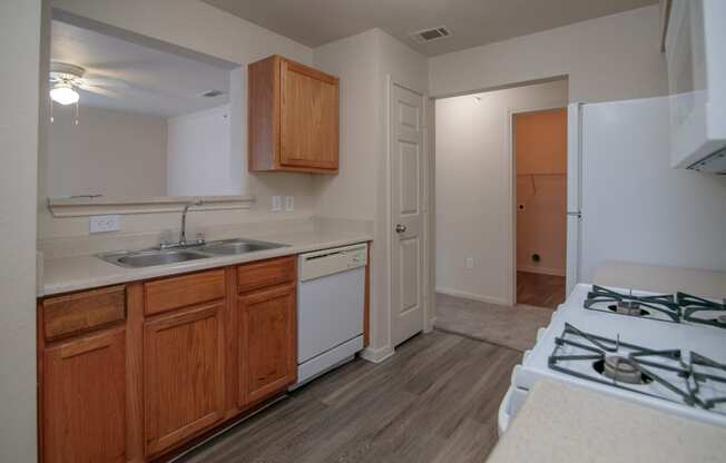 an empty kitchen with a stove top oven and a sink
