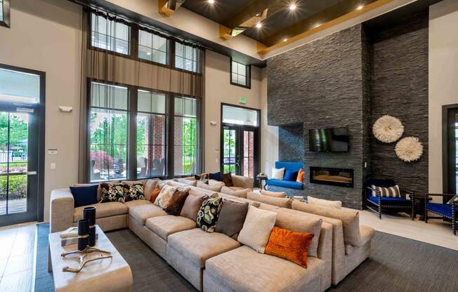 a large living room with a large couch and a fireplace