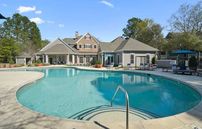 A large house with a pool in front.