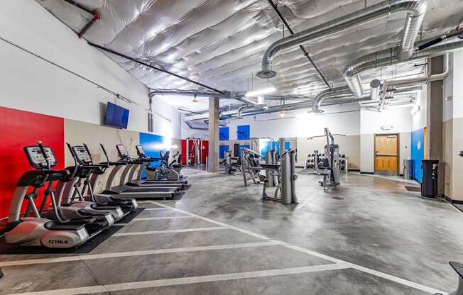 A gym with treadmills and other exercise equipment.