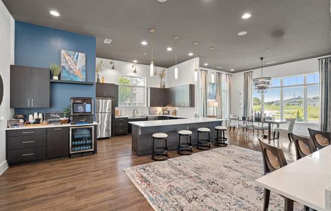 a kitchen with a large island and a dining room with a table and chairs