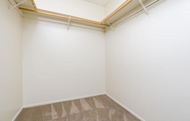 an empty room with white walls and a window