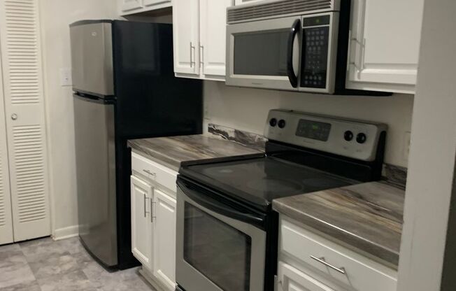 LOCATED NEAR CRABTREE-- CONDO AT MARTINIQUE-4507-c Edwards Mill Rd- LARGE LIVING ROOM-POOL ON SITE