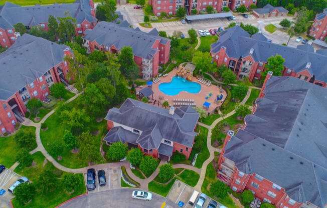an aerial view of a neighborhood with a swimming pool and parking lot
