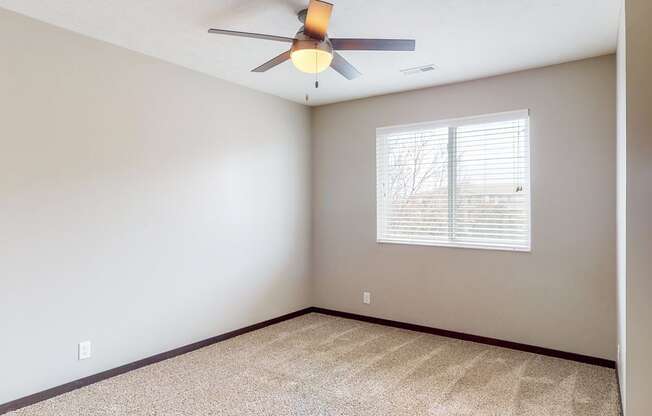 Large renovated bedroom with ceiling fan at Northridge Heights apartments in Lincoln