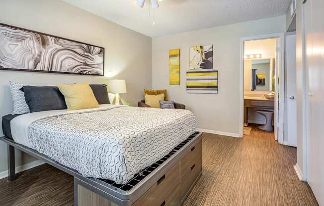 a bedroom with a bed and a bathroom with a sink at The Hub at Baton Rouge, Baton Rouge, LA 