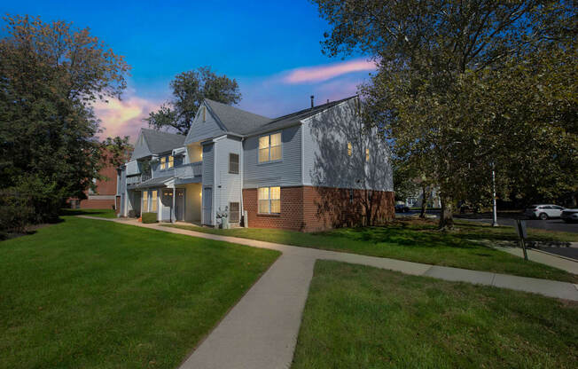 exterior view of a two story house with a sidewalk in front of it