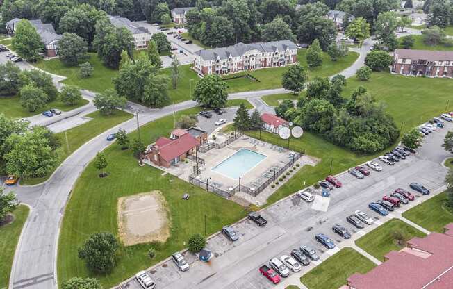 an aerial view of a swimming pool and volleyball court at West Wind Apartments, Fort Wayne