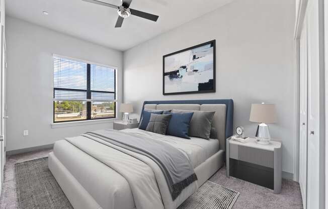 a white bedroom with a white bed and a ceiling fan