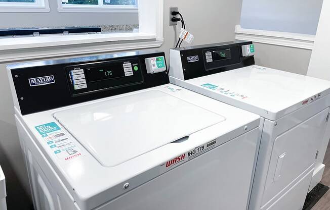 a washer and dryer sit next to each other in a laundry room