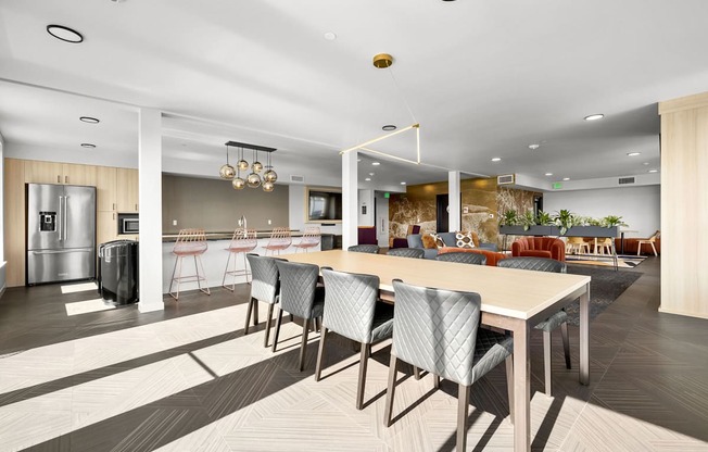 A modern kitchen with a dining table and chairs.
