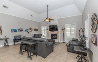 a living area with a desk and chair in a room