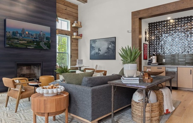 A living room with a grey couch and wooden floors.