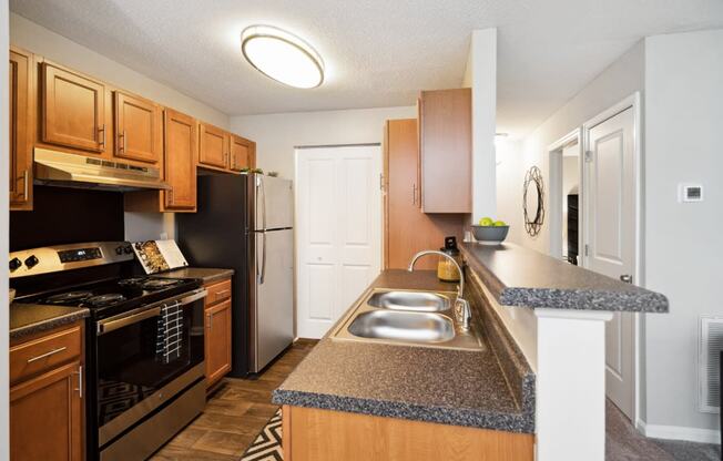 a kitchen with wood cabinets and granite countertops