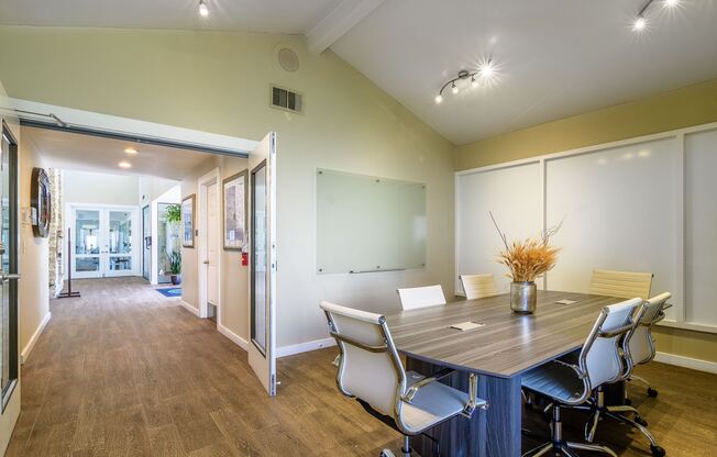 A conference room with a table and chairs.