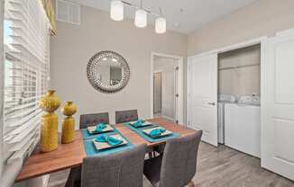 a dining room with a table and chairs and a mirror
