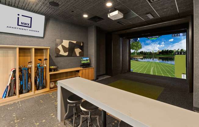 a conference room with a large screen tv and a table with chairs