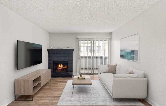 A modern living room with a fireplace and a flat screen TV.