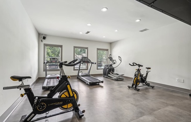 Exercise bikes is in a spacious room with treadmills