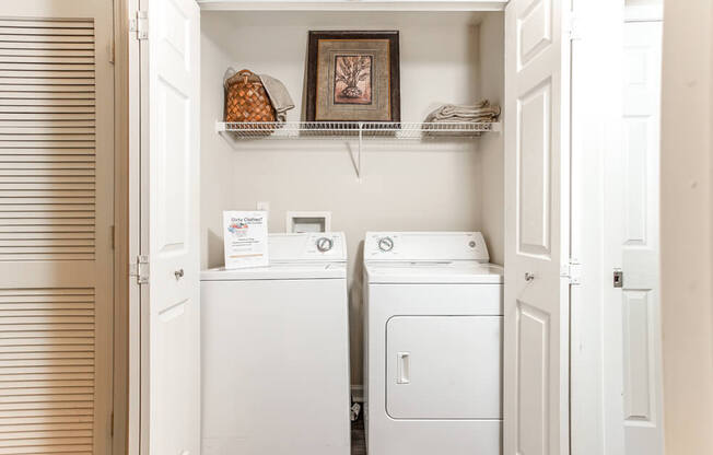 A small laundry room with a washer and dryer.