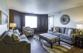 a living room with couches and chairs and a table