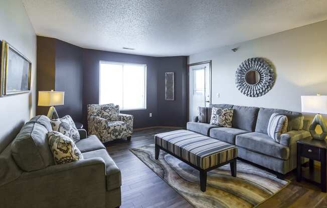 a living room with couches and chairs and a table