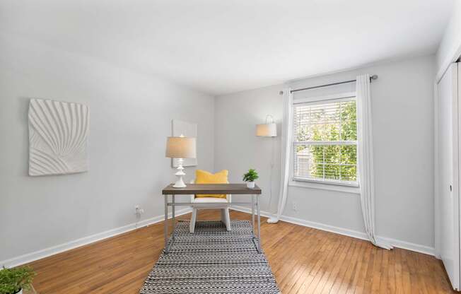 Spacious flex room at Monon Living with hardwood floors and natural light, ideal for a home office or guest space near the Monon Trail in Broad Ripple.