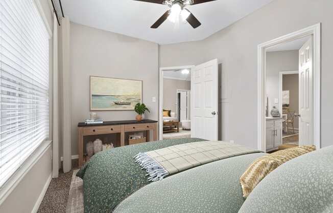 a bedroom with a large bed and a ceiling fan at Fountains of Denton in Denton, TX