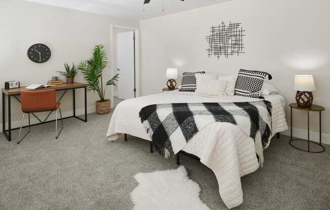 a bedroom with a bed and desk in a 555 waverly unit