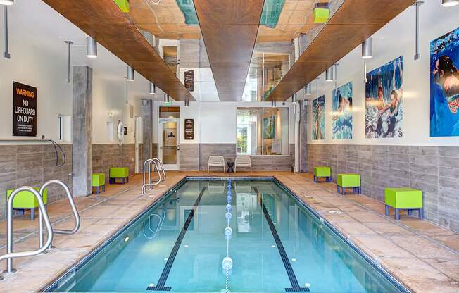 A large indoor swimming pool with a wooden ceiling