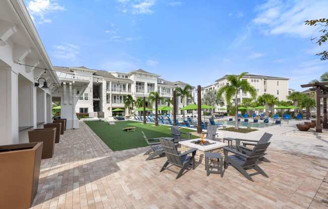 a patio with tables and chairs and umbrellas at a resort