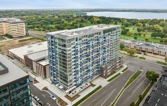 an aerial view of a tall building on the corner of a city street