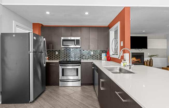 a kitchen with stainless steel appliances and white counter tops