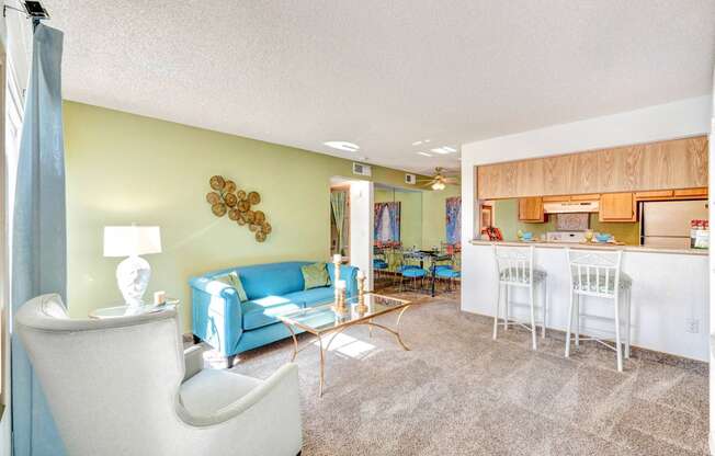 Bright living room with pass through kitchen at with Cardio & Strength Training Equipment at Country Club at The Meadows in Las Vegas, NV!
