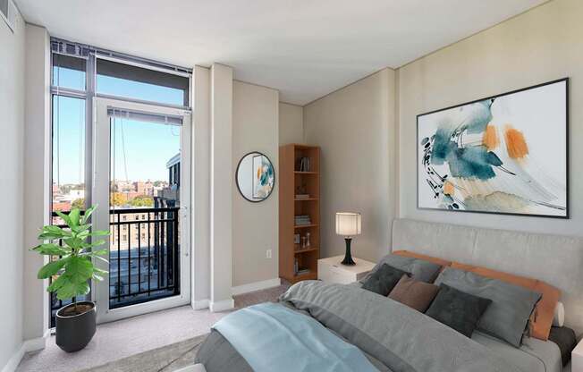 a bedroom with a bed and a sliding glass door to a balcony