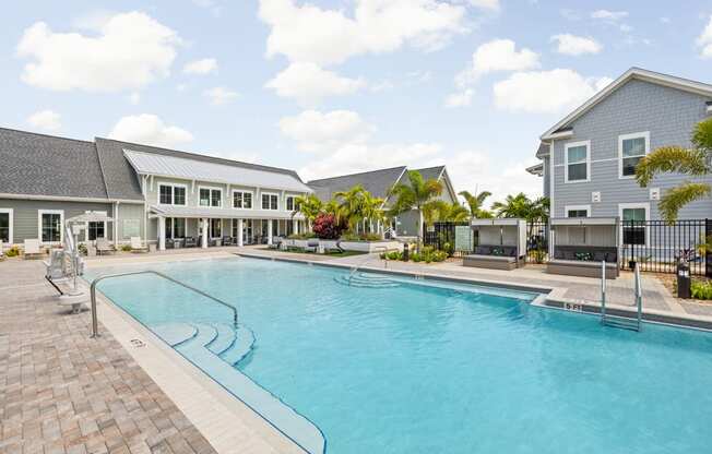 a large swimming pool in front of a building at Palm Grove in Ellenton, FL 34222