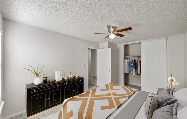 A living room with a black and white color scheme and a ceiling fan.