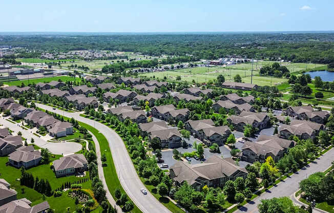 A suburban neighborhood with houses and a winding road.