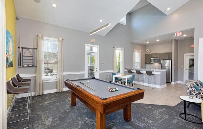 a game room with a pool table and a bar