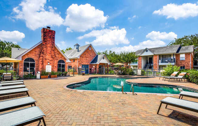 A brick house with a pool in the backyard.